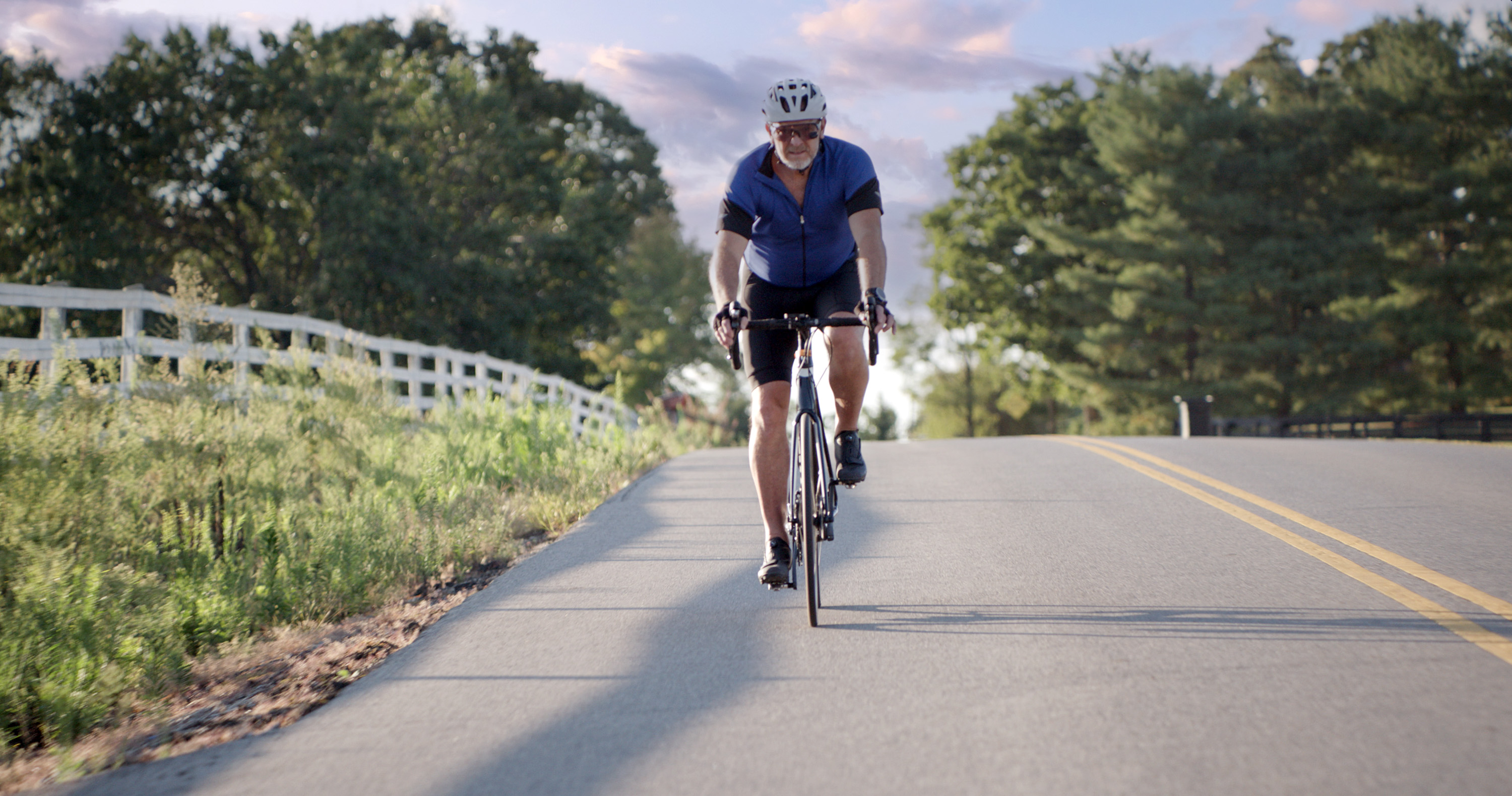 Man riding bicycle on country road