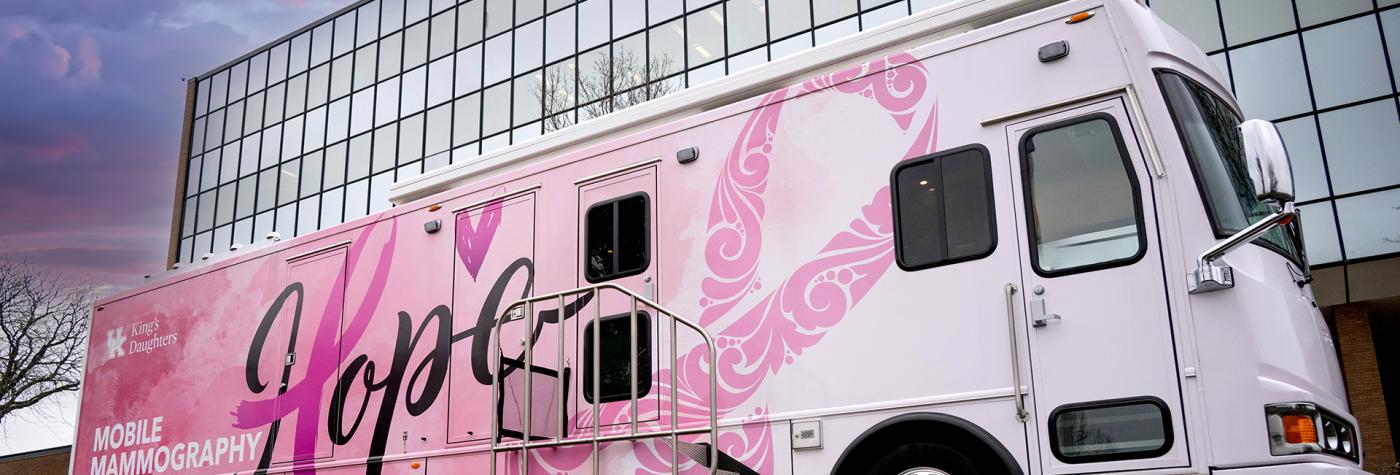 A mobile mammography unit with encouraging graphics and pink ribbons designs.