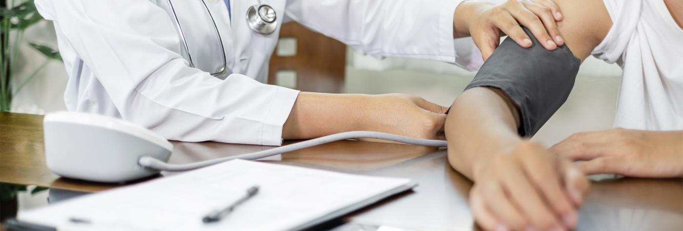 Healthcare provider takes a patient's blood pressure