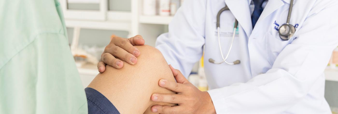 Healthcare provider examines a patient's knee