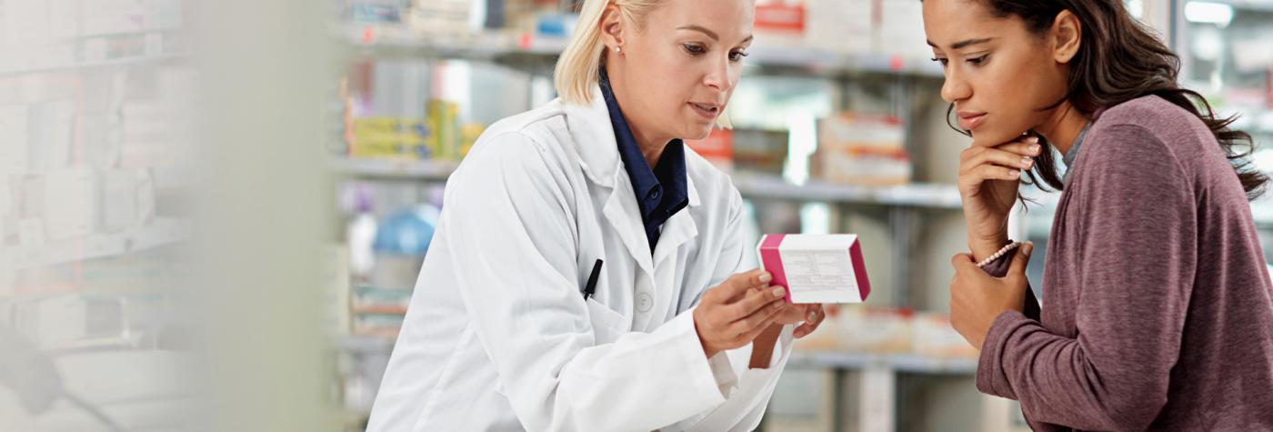 Pharmacist helps patient with prescription at the pharmacy 