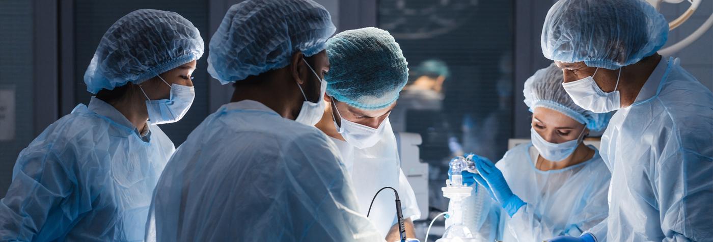 Healthcare providers operate on patient in an operating room.