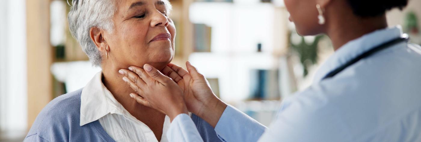 Healthcare provider checks a patient's lymph nodes in their throat