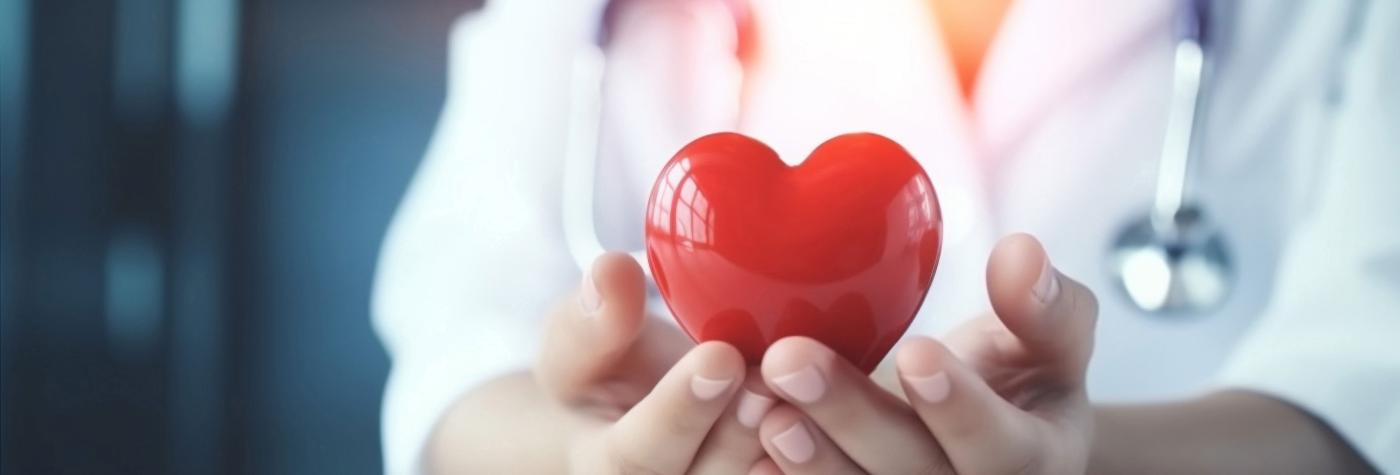 Nurse holding heart shaped item.