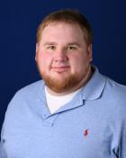 Portrait of man wearing polo shirt